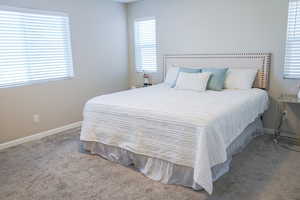 Carpeted bedroom featuring baseboards
