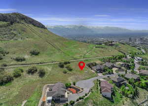 Aerial view of property's location featuring a mountainous background and nearby suburban area