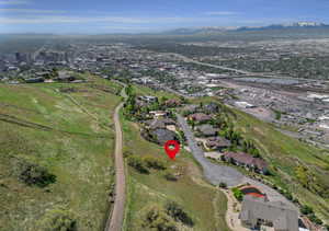 Aerial view of property's location featuring nearby suburban area and a mountainous background