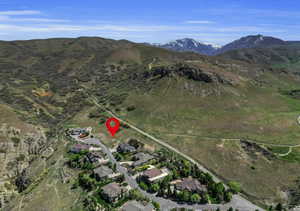 View of property location featuring mountains and nearby suburban area