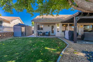 Back of property featuring a patio area, stucco siding, a tile roof, and an outbuilding