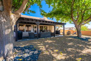 Rear view of house with a patio area, a chimney, outdoor lounge area, and a tile roof
