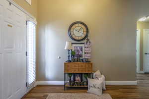 Foyer entrance featuring wood finished floors and baseboards