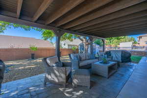 Fenced backyard featuring a patio, a shed, and an outdoor living space