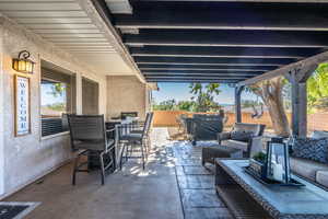 Fenced backyard with a patio area, an outdoor hangout area, area for grilling, and outdoor dining area