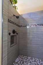 Bathroom featuring tiled shower