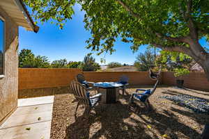 Fenced backyard with a patio and a fire pit
