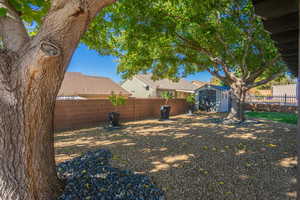 Fenced backyard with a storage unit