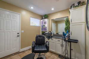 Office with light tile patterned floors and recessed lighting