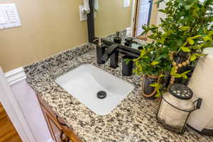 Bathroom featuring vanity and a textured wall