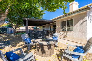 View of patio / terrace featuring a storage shed, an outdoor fire pit, and outdoor dining space