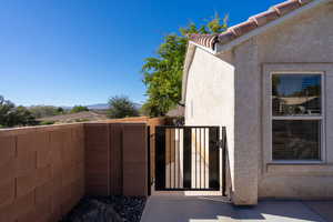 View of property exterior featuring a gate and stucco siding