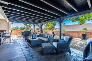 Fenced backyard featuring a patio area and outdoor lounge area