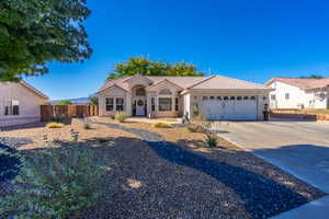 View of front of property featuring a tiled roof, concrete driveway, stucco siding, and an attached garage