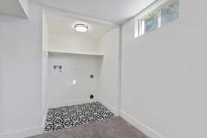 Laundry room featuring washer hookup, hookup for an electric dryer, tile patterned floors, and carpet