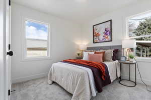 Bedroom featuring carpet and baseboards