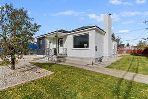 View of front of home with a chimney and brick siding