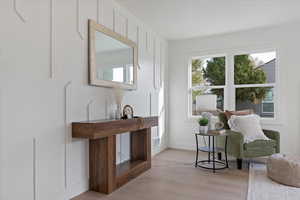 Sitting room with light wood-type flooring and baseboards