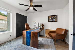 Home office featuring ceiling fan and light wood finished floors