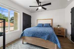 Bedroom with wood finished floors and a ceiling fan