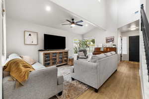 Living area with wood finished floors, a ceiling fan, high vaulted ceiling, beamed ceiling, and recessed lighting