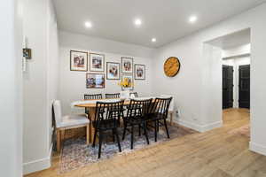 Dining area featuring light wood-type flooring and recessed lighting