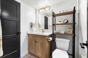 Bathroom featuring vanity and toilet