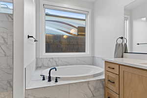 Bathroom featuring a bath and vanity