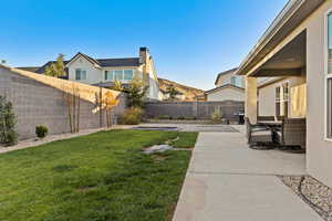 Fenced backyard featuring a patio and a mountain view