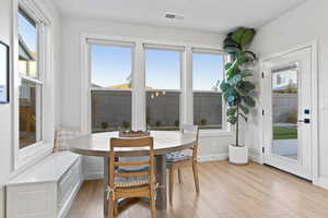 Dining area featuring light wood-style flooring and baseboards