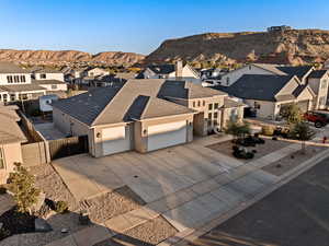 View of front facade with a residential view, an attached garage, driveway, and a mountain view