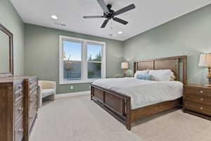 Bedroom with light carpet, a ceiling fan, and recessed lighting