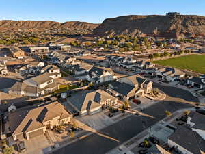 Aerial overview of property's location with nearby suburban area and mountains