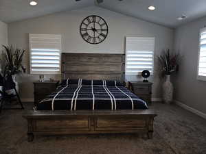 Owners suite with vaulted ceiling, recessed lighting, and ceiling fan