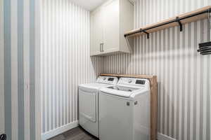 Separate Laundry room with cupboard, hanging rod and closet