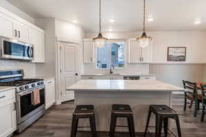 Perfectly functional kitchen with quartz countertops and painted wood cabinets