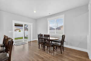 Dining space with plenty of natural light, wood finished floors, and recessed lighting