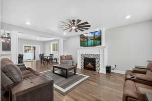 Living area with recessed lighting, wood finished floors, a fireplace, and ceiling fan