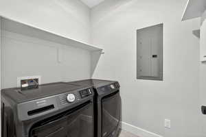 Laundry room featuring washer and dryer, and tile flooring and built-in shelving