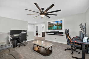 Second floor loft area featuring light carpet, a built-in entertainment center and a ceiling fan
