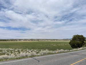 View of asphalt road with a rural view