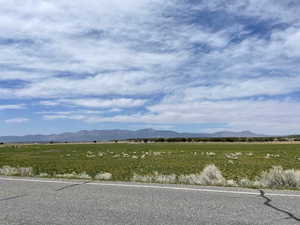 View of mountain backdrop featuring rural landscape