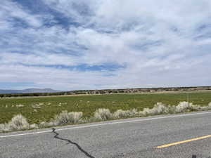 View of asphalt street featuring a view of rural / pastoral area