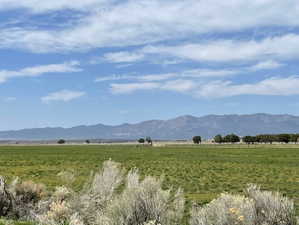 View of mountain backdrop featuring rural landscape and agricultural land