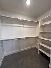 Walk in closet featuring dark carpet