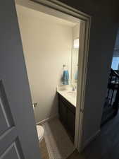 Bathroom featuring vanity and dark wood finished floors
