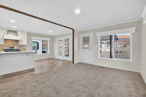Unfurnished living room featuring ornamental molding, carpet floors, and recessed lighting