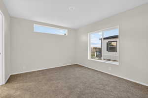 Carpeted empty room with healthy amount of natural light