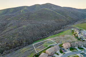 Aerial view at dusk of property boundaries highlighted and a mountain view