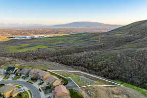 Aerial view of property's location featuring property parcel outlined and a mountainous background
